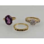 A 9 carat yellow gold and amethyst ring, together with a CZ set costume ring,