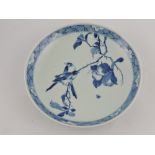 A late 19th century Chinese blue and white dish, decorated with birds on a fruiting branch,