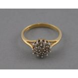 A diamond cluster ring, set in a 9ct gold band, 1.6g.
