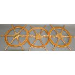 Three hardwood six spoke decorative ship's wheels, D. 65cm, (3).