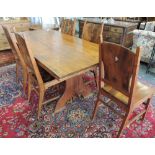 A contemporary elm dining suite comprising a rectangular refectory table on shaped trestle ends,