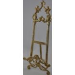 A cast brass table top easel of rococo design, H.