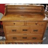 A late 19th Century East European pine chest of drawers with raised shelf back over 2 short and 2