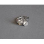 A two stone diamond crossover ring, approx 2ct total weight set in a white metal band, 6.1g.