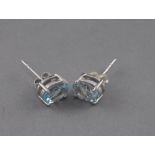 A pair of silver and aquamarine ear studs