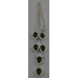 A silver six stone necklace set with heartshape peridot colour stones