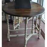 A small 1920s gate leg oak table on a later painted spiral turned under frame,