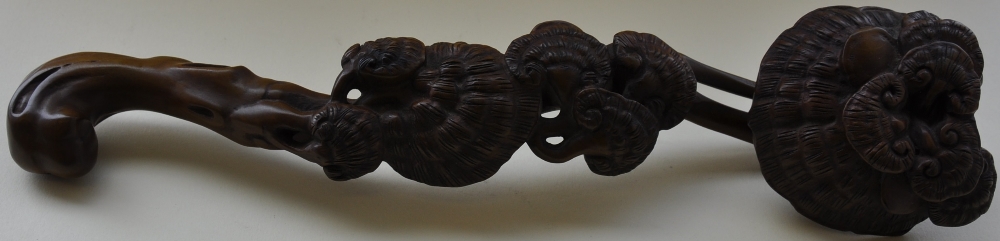 A Chinese carved hardwood rhyi, depicting tree canopies, L. 37cm.