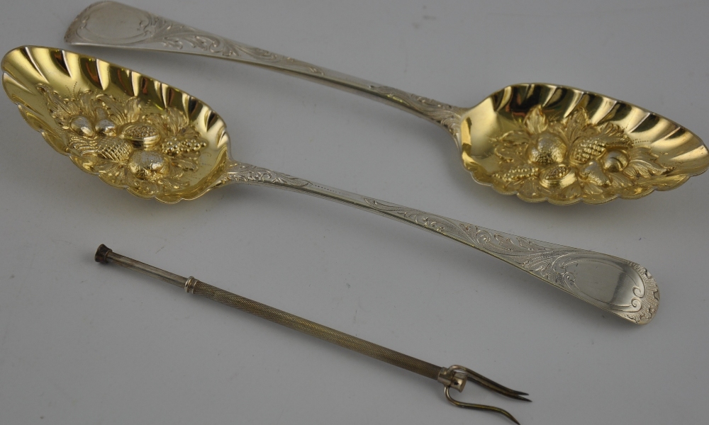 A pair of berry spoons, London 1799, with later repousse decoration and gilded bowls,
