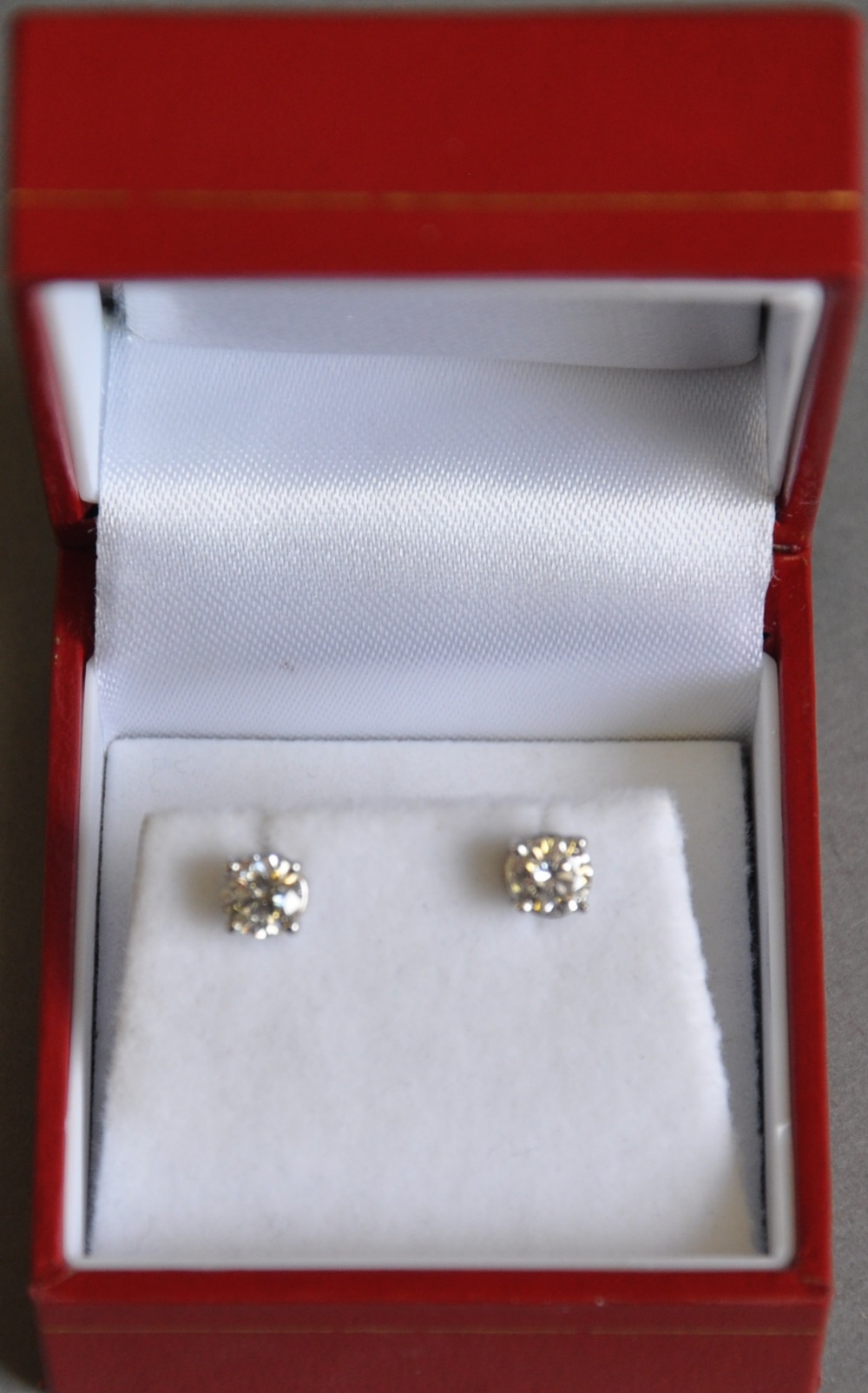 A pair of diamond ear studs, claw set in white metal stamped 14kt, 1g.