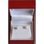 A pair of diamond ear studs, claw set in white metal stamped 14kt, 1g.