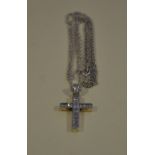 A white metal cross set with clear stones, stamped 925, on a fine chain.