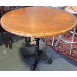 A circular table with a decorative cast metal support, D. 80cm.