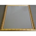 A rectangular wall mirror, with a bevelled plate within a gilt faux bamboo frame, 70 x 100cm.
