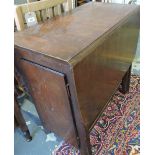 An oak drop leaf table, the pedestal end support incorporating a cupboard, W.