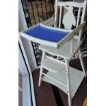 A 1950's metamorphic white wood high chair with penguin splat back.