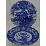 A 20th century blue and white charger, with ascalloped ring and decorated with a garden scene, D.