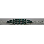 An articulated silver bracelet set oval pale green stones