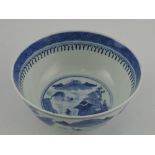 A 19th century Chinese blue and white bowl, decorated with a mountainous river village landscape,