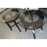 An ebonised circular glass topped table, the bevelled top on square tapering legs, D: 137cm,