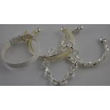 A woven white metal bangle in the form of a belt, together with two further bangles and a bracelet,