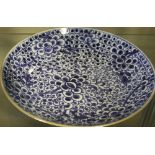 A Chinese blue and white dish, with intense blossom pattern decoration, D. 24cm.