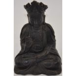 A Chinese bronze Buddhist figure, seated with right hand raised, H. 23cm.