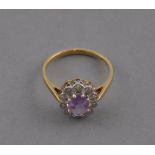 An amethyst and diamond cluster ring, set in yellow metal, 2.1g.