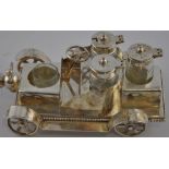 A novelty silver plated four bottled cruet modelled as a vintage car,