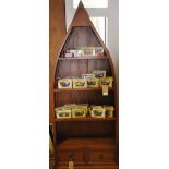 A contemporary pine open bookcase modelled as a boat bow, fitted 2 drawers on plinth foot,