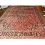 A Persian red ground Tabiz carpet, having a central medallion to centre on a floral patterned