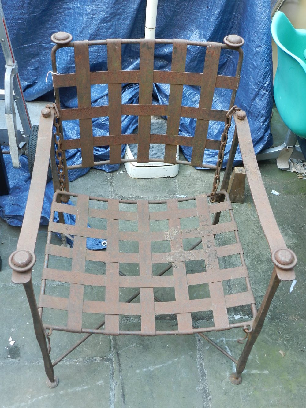 A cast iron arm chair, having lattice work back rest and seat.