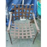 A cast iron arm chair, having lattice work back rest and seat.