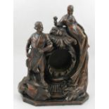 A coated bronze clock holder, modelled with classical figures, raised on a octagonal base, H.
