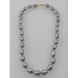 A strand of Tahitian pearls, of grey-silver colour, with a 14 carat yellow gold clasp.