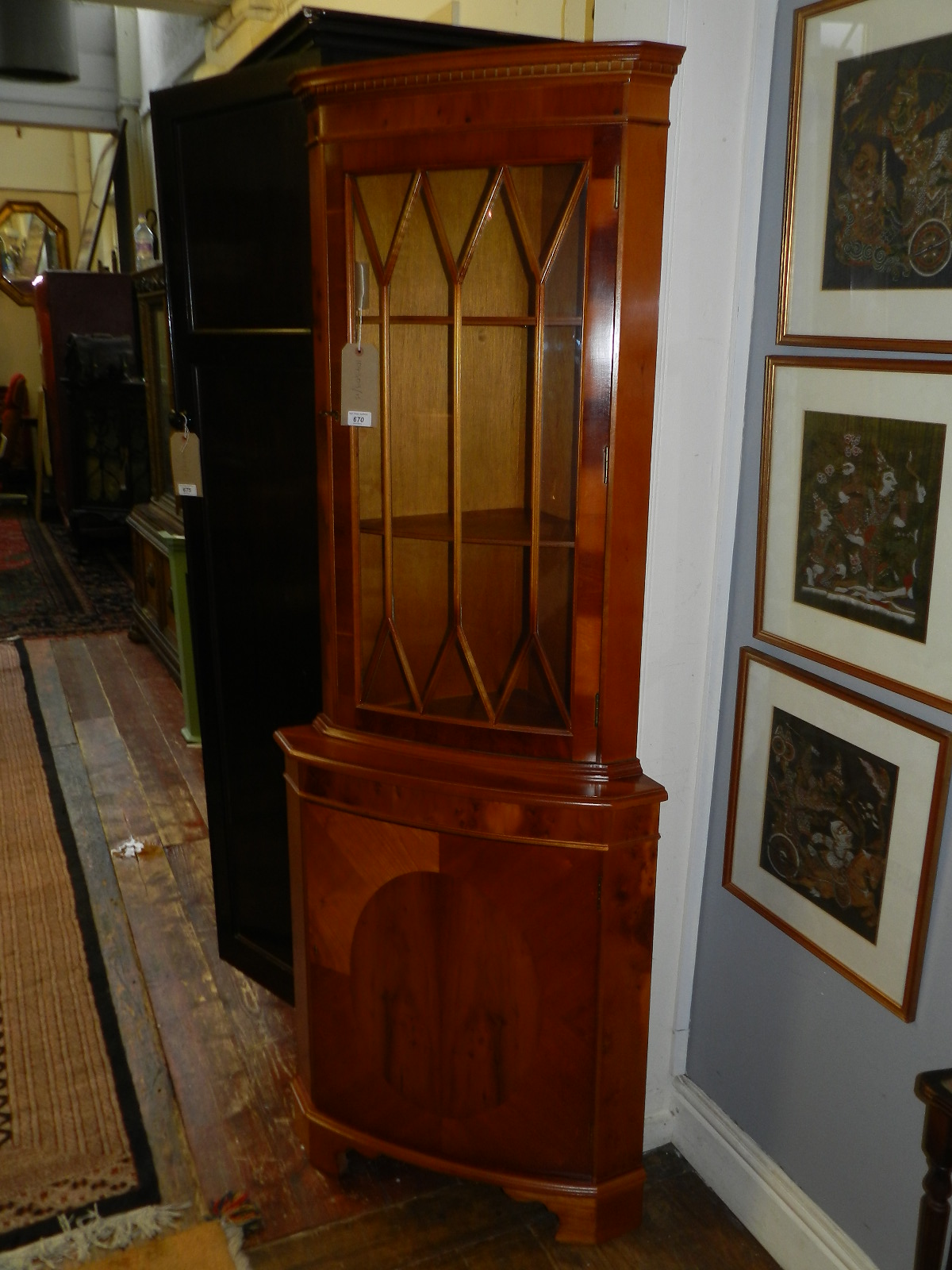 A 19th century style yew wood corner cabinet, single cupboard door below astragal glazed door. H: