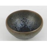 A Chinese Jian kiln tea bowl, glazed in black and brown.H.4.