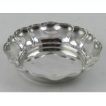 A silver bowl of circular form with waved rim, bears makers mark for Baker Ellis.