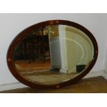 An Edwardian oval-framed mirror, marquetry inlaid. H: 57cm W: 82cm