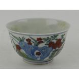 A Ming style porcelain tea bowl, decorated with chickens in landscape,