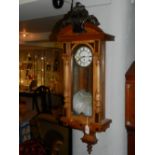 A late 19th century walnut Vienna wall regulator clock, having ebonised central crest,