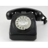 A mid 20th century black dial telephone.