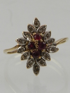 A 10 carat yellow gold, diamond, and ruby cluster ring.