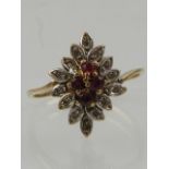 A 10 carat yellow gold, diamond, and ruby cluster ring.