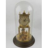 A 20th century brass anniversary clock with glass dome.