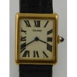 A Cartier gents 18ct tank wristwatch, having black leather strap and original case.