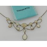 A silver and opal set pendant necklace, in the Edwardian taste, set oval cut cabouchon opals.