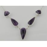 A white metal and amethyst set pendant drop necklace, the clasp stamped 925.