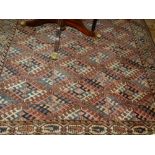 A red ground Turkoman carpet, having multi diamond shaped medallions to centre within many borders,