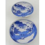 A pair of blue and white Chinese Kangxi style porcelain dishes, decorated with figures in landscape,